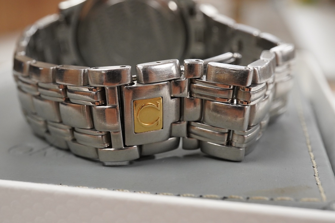 A gentleman's 1990's stainless steel Omega Seamaster quartz wrist watch, with blue dial dot markers and date aperture, case diameter 36mm, on a stainless steel Omega bracelet, with box and papers.